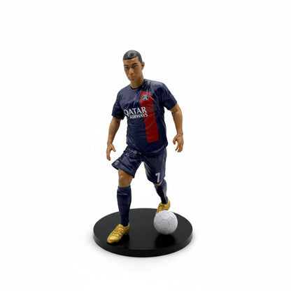 Realistic Kylian Mbappé collectible football figurine in Paris Saint-Germain home kit with a soccer ball.