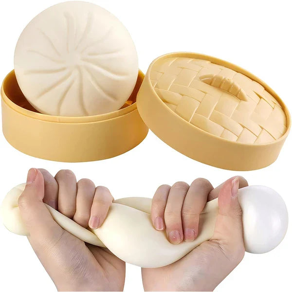 White squishy dumpling sensory toy with storage case, shown stretched by hand for tactile fidget play, stress relief and calming sensory fun.